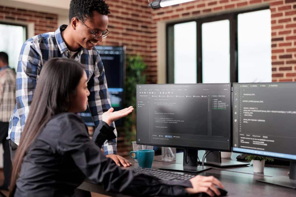 programmers questioning source of cyber attacks and system security coverage software technician triangulates hacker location by updating safety script codes and data processor sequencer 1 1